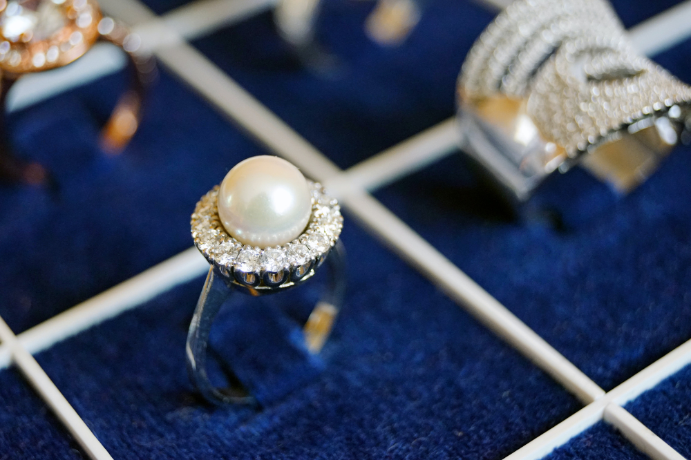 A display featuring various rings, including a pearl ring up close